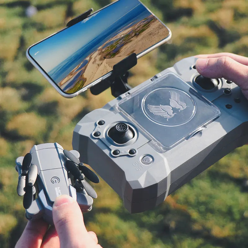 Mini folding 4K camera drone with plastic body and storage bag on a desk