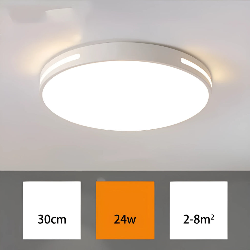 Round modern acrylic LED ceiling lamp with remote control on a white bedroom ceiling