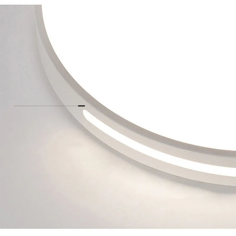 Round modern acrylic LED ceiling lamp with remote control on a white bedroom ceiling