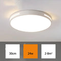 Round modern acrylic LED ceiling lamp with remote control on a white bedroom ceiling
