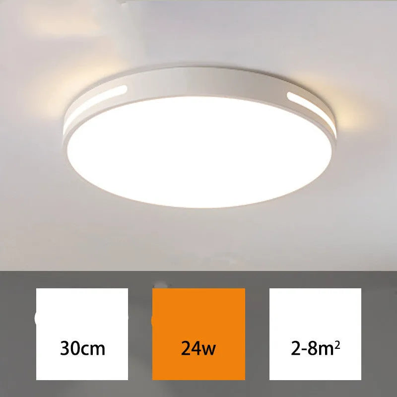 Round modern acrylic LED ceiling lamp with remote control on a white bedroom ceiling