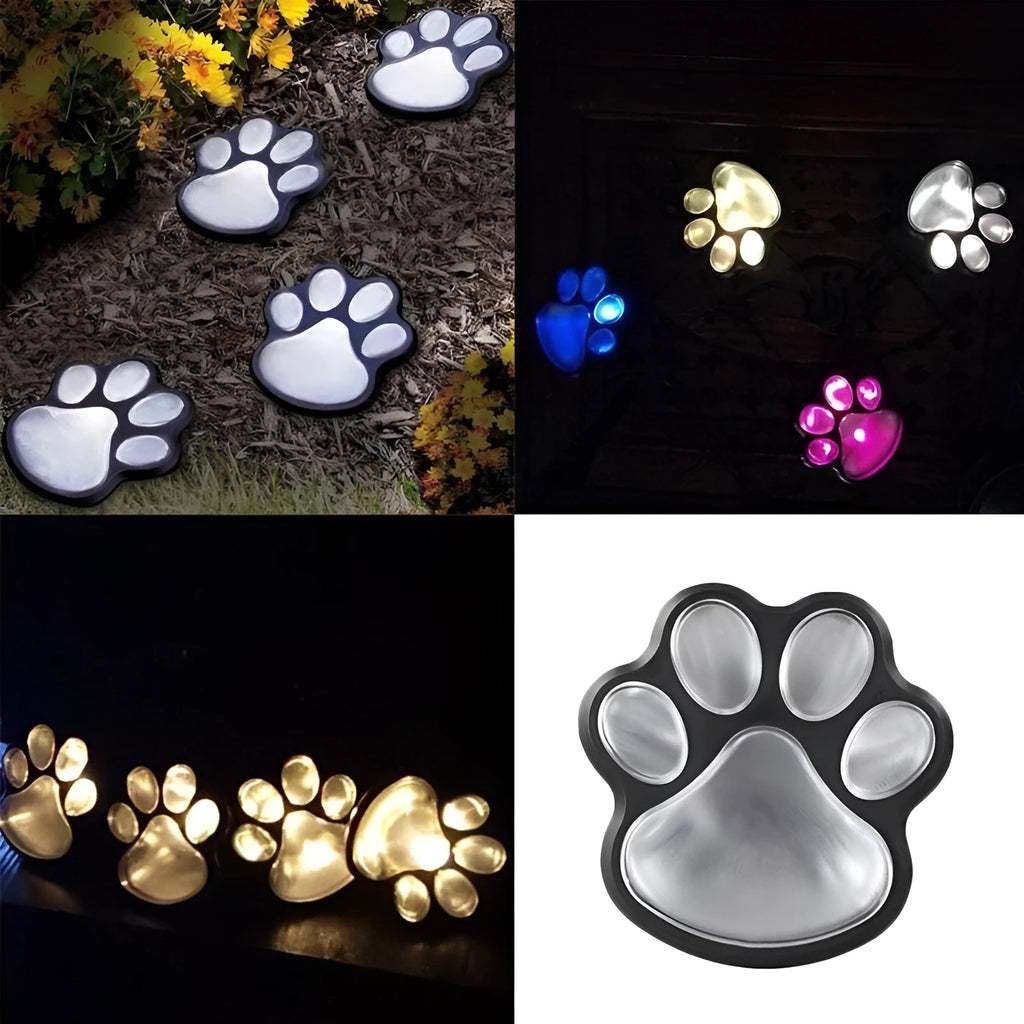 Black bear paw print shaped solar garden lights installed along a garden path.