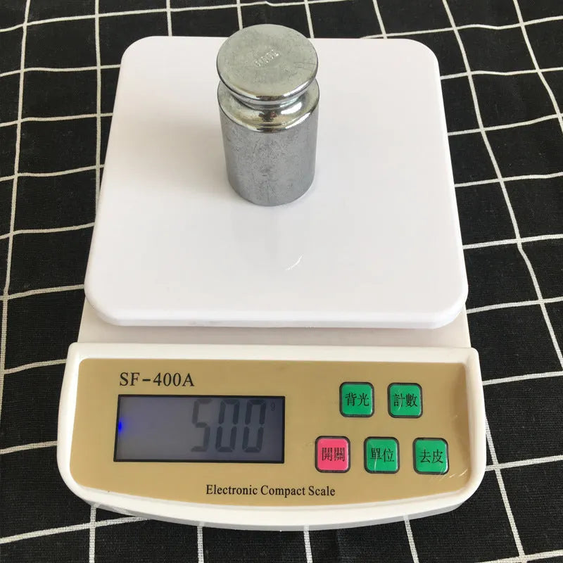 SF-400A black electronic digital kitchen scale with LCD display on a kitchen counter.