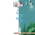 Blue mobile phone holder with memory alloy hose attached to bed frame holding phone
