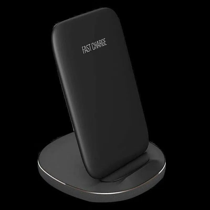Vertical wireless charging dock in white or black colour on a desk charging a smartphone