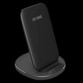 Vertical wireless charging dock in white or black colour on a desk charging a smartphone