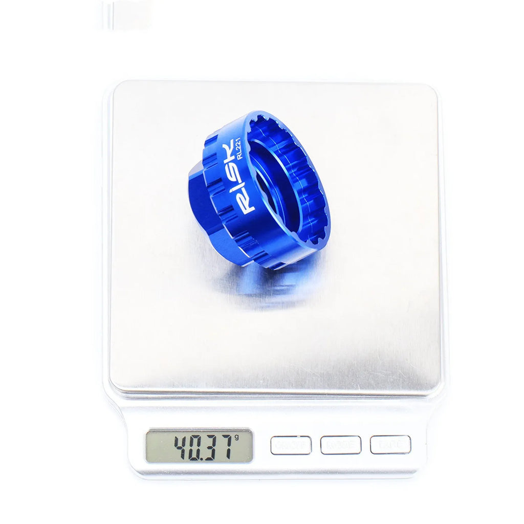Blue aluminium alloy 12-speed direct mount disc brake removal tool on a workshop bench