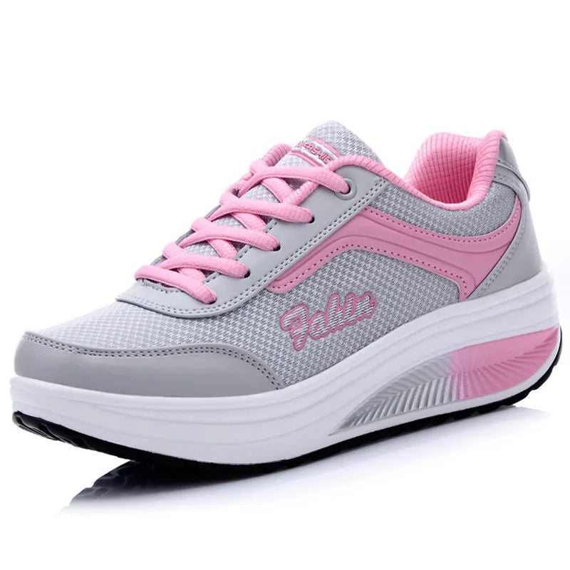 Women's grey powder heelless sports travel flats with a medium heel on a white background.