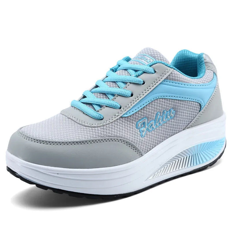 Women's grey powder heelless sports travel flats with a medium heel on a white background.