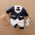 Gentleman's style long sleeve cotton baby romper one-piece laid flat.
