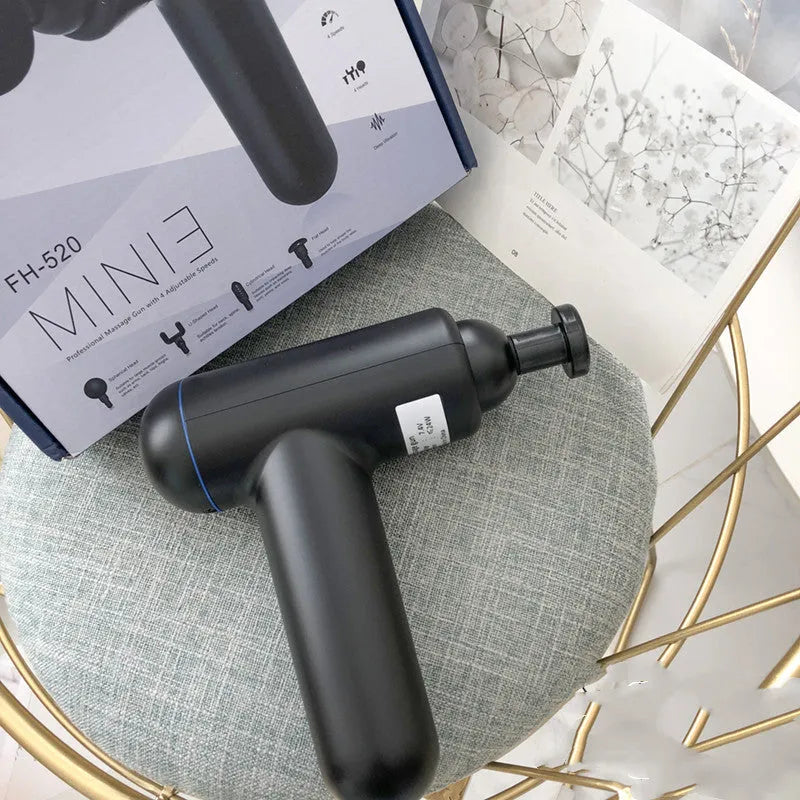 Black handheld USB fascia gun massager with 24W motor on a grey background.