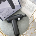 Black handheld USB fascia gun massager with 24W motor on a grey background.