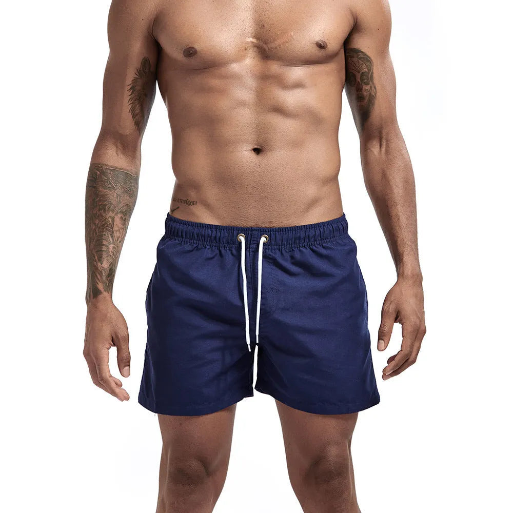 Three-point beach pants in polyester, straight loose sports shorts with multi-pocket detail, plain casual style for summer