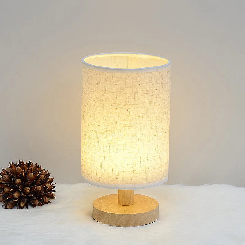 Wooden cloth cover table lamp with solid wood shade, LED light, push button switch, and USB outlet in grey linen or yellow jute.