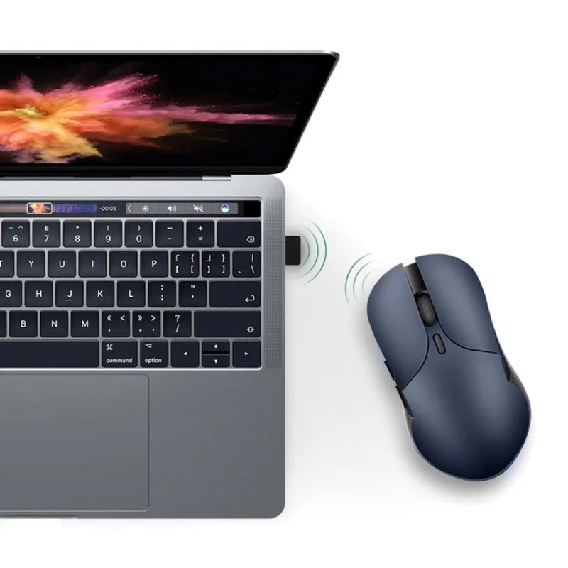 Blue Smart Voice Mouse with translation button on a desk next to a laptop.