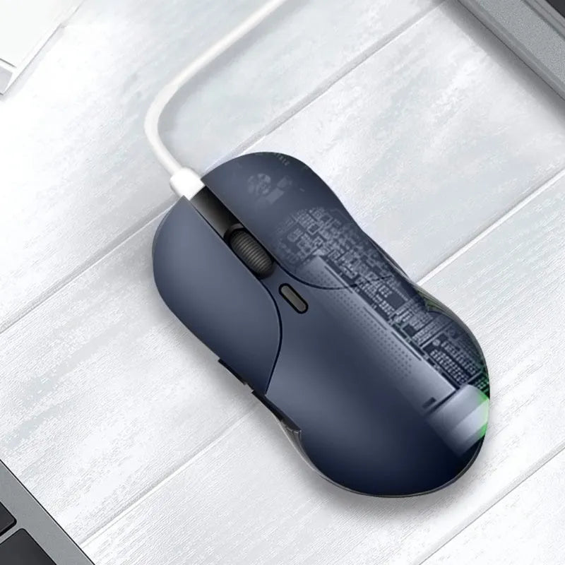 Blue Smart Voice Mouse with translation button on a desk next to a laptop.