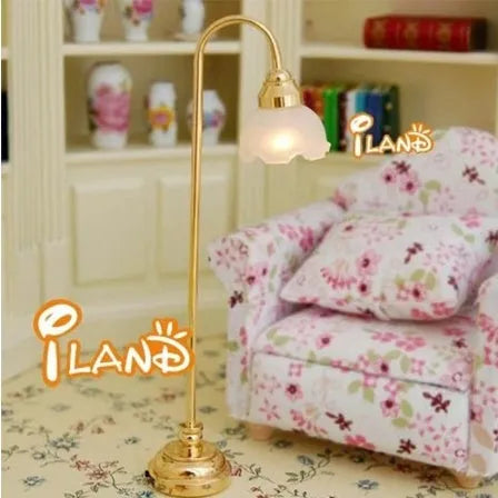 Miniature dollhouse LED floor lamp with glass shade on wooden surface