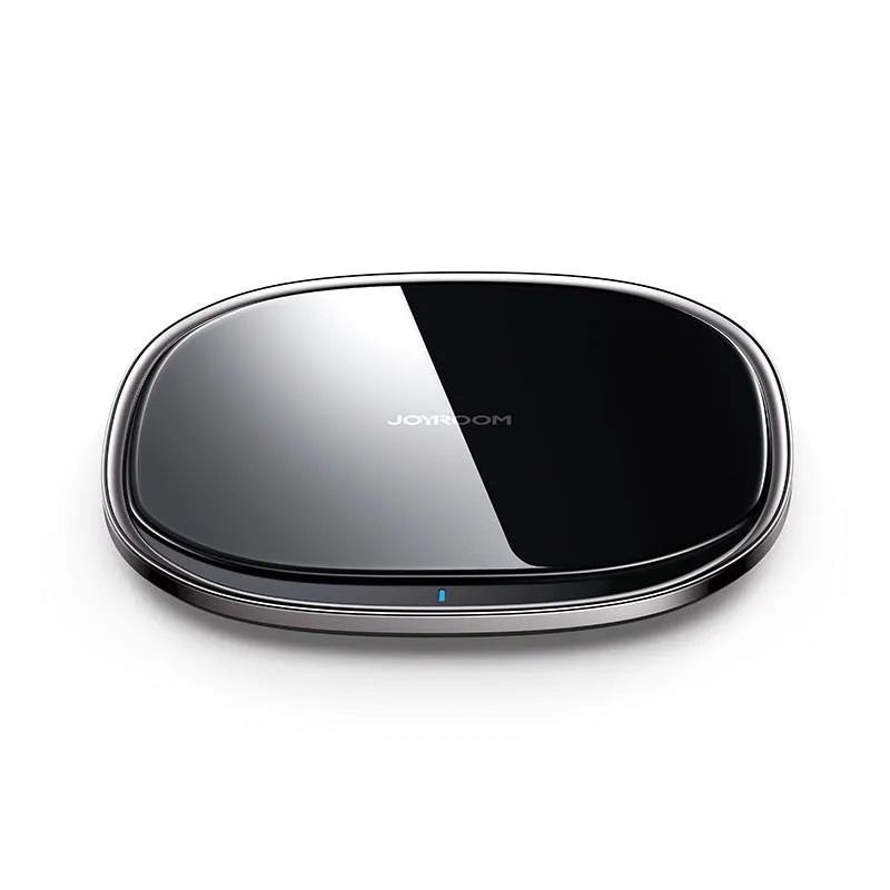 Black or white 15W wireless charging pad with zinc alloy and glass construction on a desk.