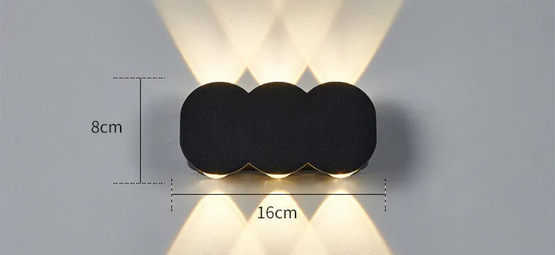 Modern minimalist square or rectangular LED wall light with a clean diffuser, mounted on an exterior brick wall.