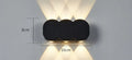 Modern minimalist square or rectangular LED wall light with a clean diffuser, mounted on an exterior brick wall.