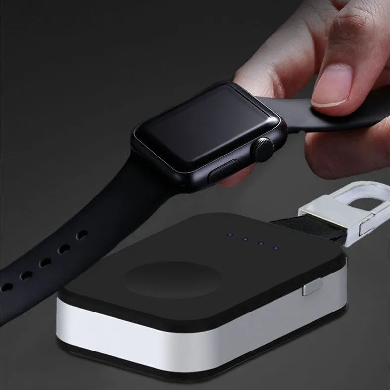 Black portable keychain power bank for wireless charging of an Apple Watch.