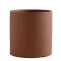 Colourful cylindrical ceramic succulent planter with drainage hole on a wooden surface