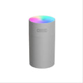 Pink USB portable humidifier with atmosphere lights on desk surface