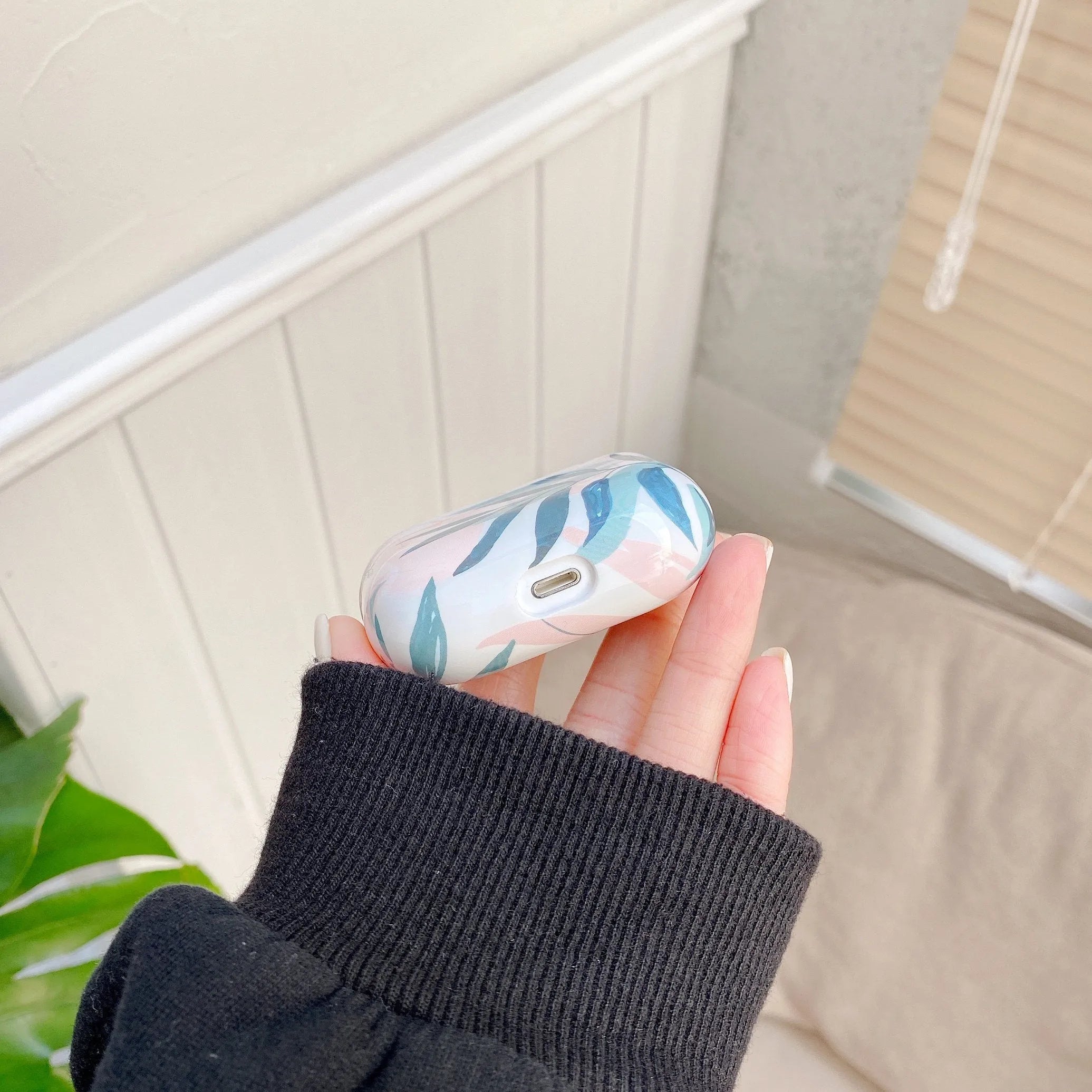 Blue TPU earphone case with banana leaf design for Apple AirPods Pro.