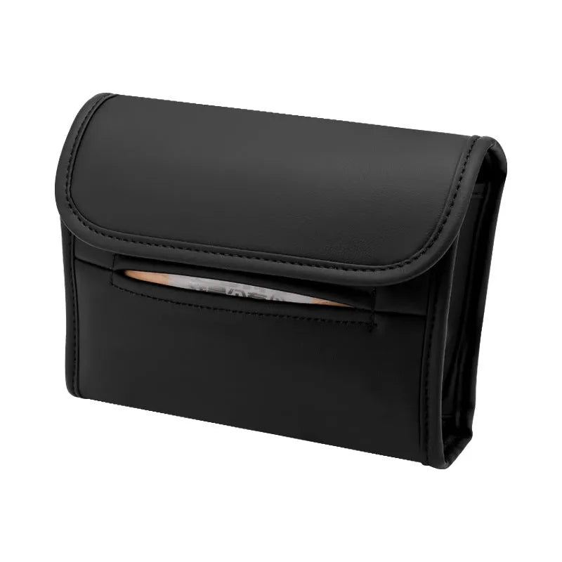 Brown leather car tissue box with elastic strap hanging on a car seat back.