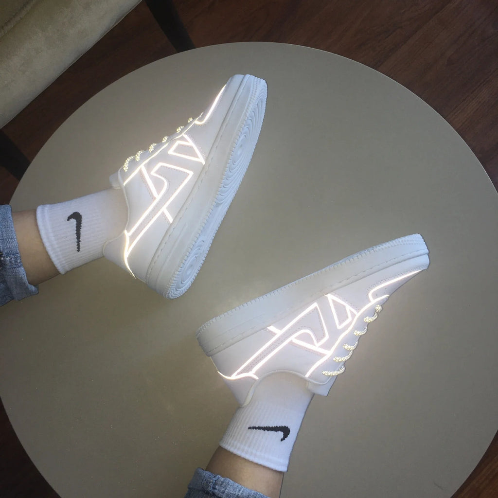 Reflective white unisex low top sneaker with lace up closure, synthetic leather upper, and TPR sole