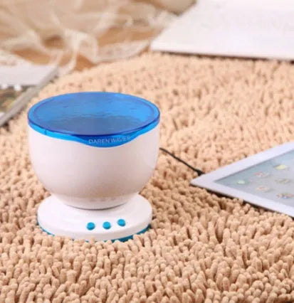 Blue coloured ocean-themed LED projection lamp on a surface for children's puzzle activities.