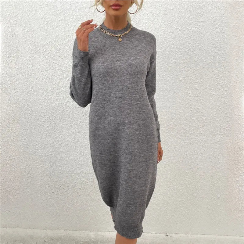 Grey women's crew neck pullover sweater with long sleeves on a hanger.
