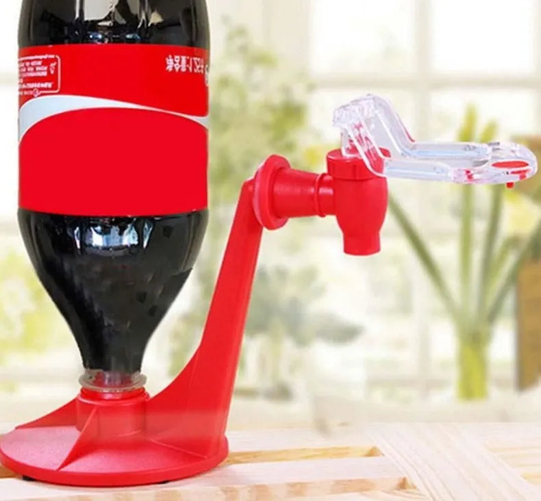 Red plastic Magic Tap soda drink dispenser attached to an inverted 2-litre bottle
