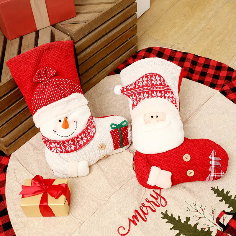 Large red and white knitted Christmas stocking with Santa Claus design hanging from fireplace