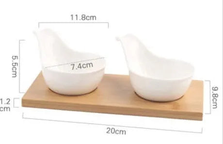 Porcelain ceramic dried fruit dish with three snack compartments on a wooden serving board.