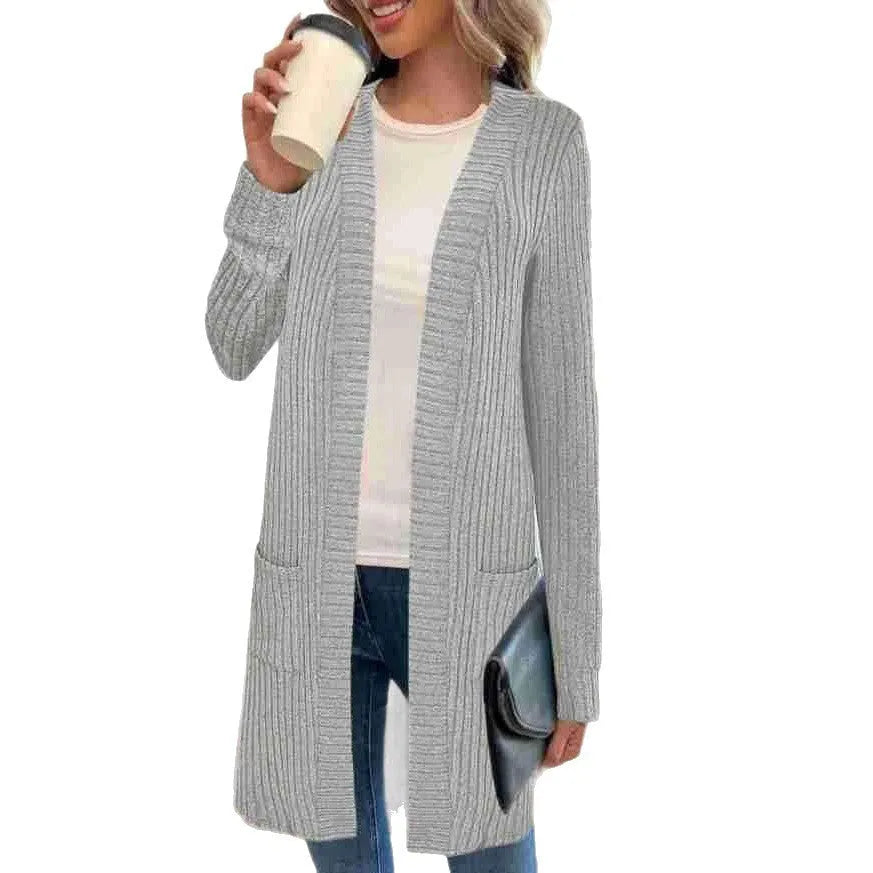 Long sleeve loose knitted cardigan jacket in black, shown with side pockets.