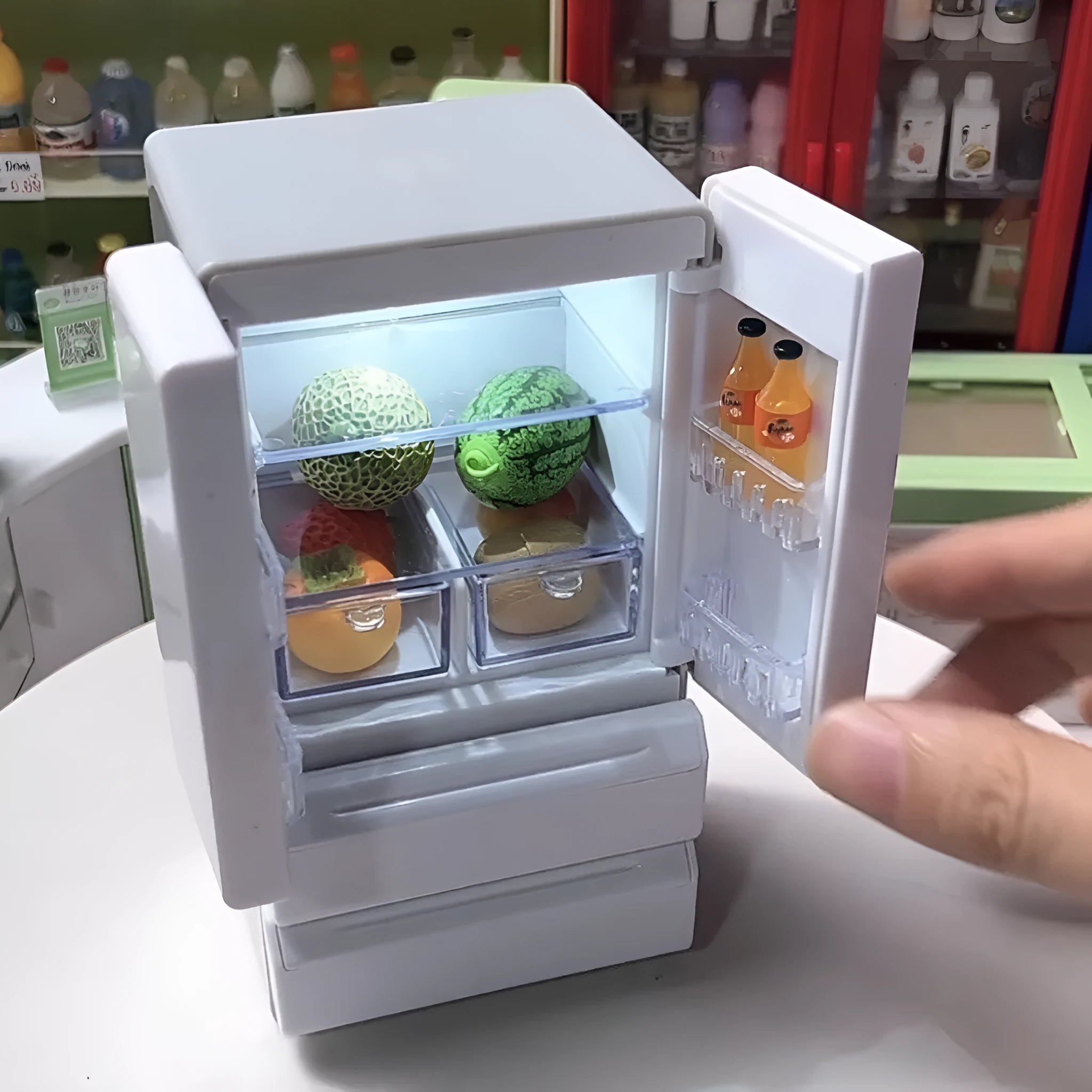 White plastic miniature candy shop model with LED light on, showing detailed front.