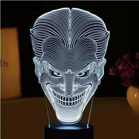 A 3D acrylic LED lamp emitting a gradient of colours, shown with its square base and remote control.