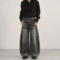 Men's loose straight washed denim jeans in black, front view showing zip fly and straight leg cut.