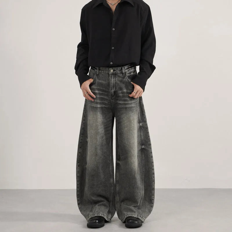 Men's loose straight washed denim jeans in black, front view showing zip fly and straight leg cut.
