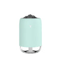 Mini cylindrical USB ultrasonic humidifier in white, pink, or green with warm night light on.