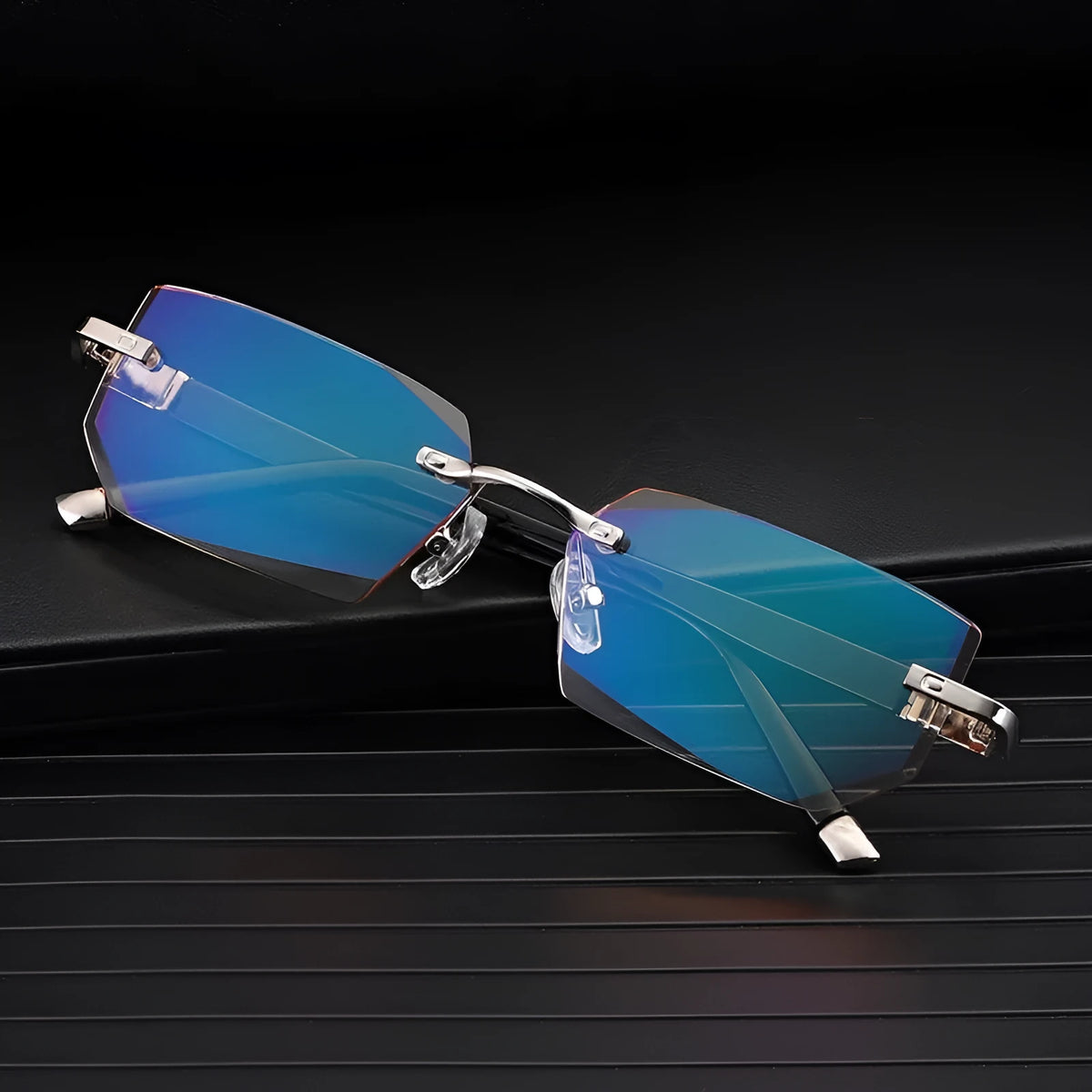 Diamond-cut metal reading glasses with tan frame and black lenses on a plain background
