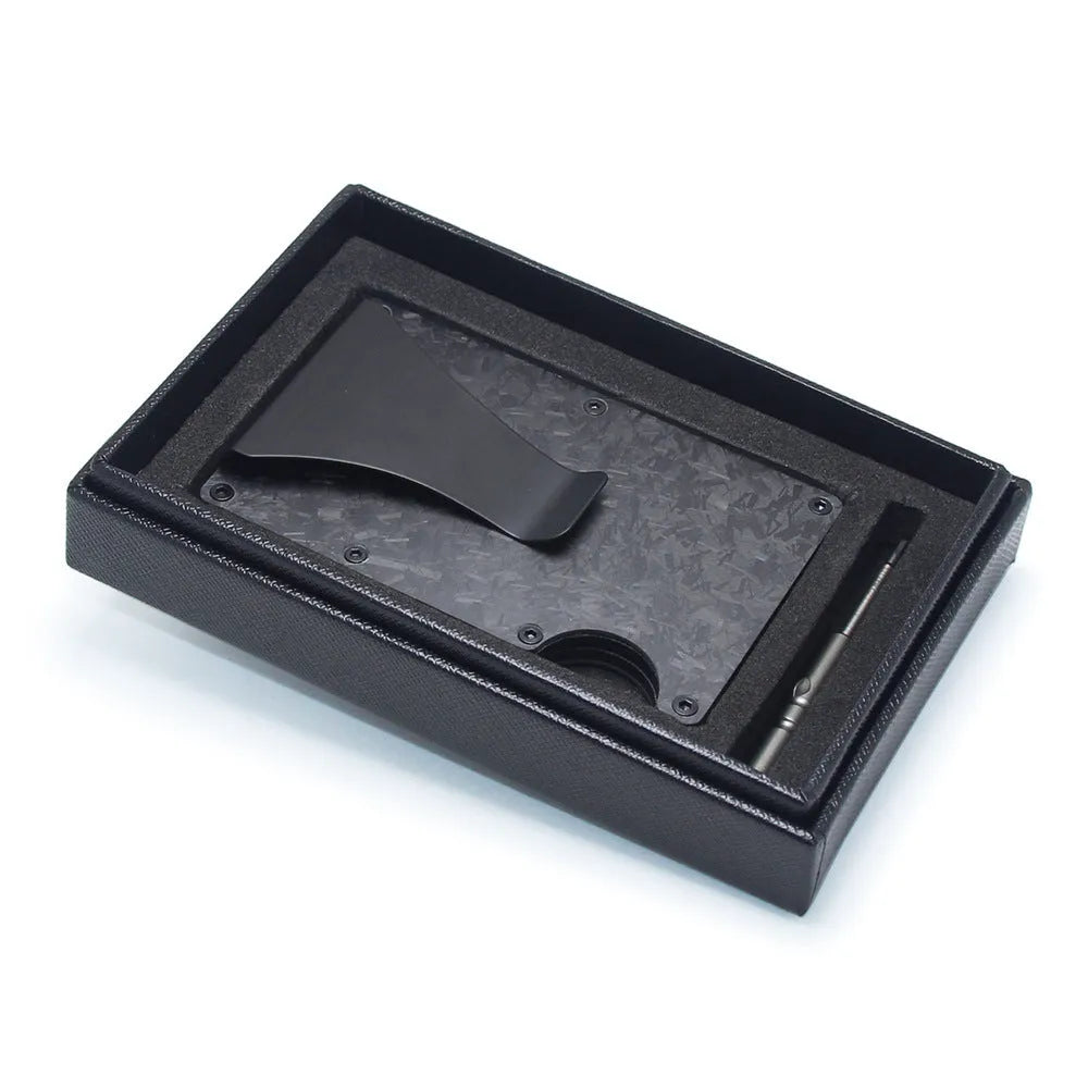 Slim black carbon fibre card holder wallet with geometric design on a desk.