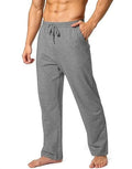 Men's loose fit casual trousers in black polyester fabric on a hanger.