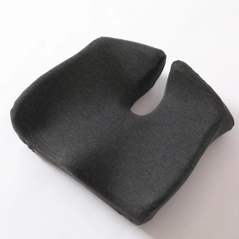 A black memory foam office chair cushion measuring 36 by 40 centimetres on a desk chair.