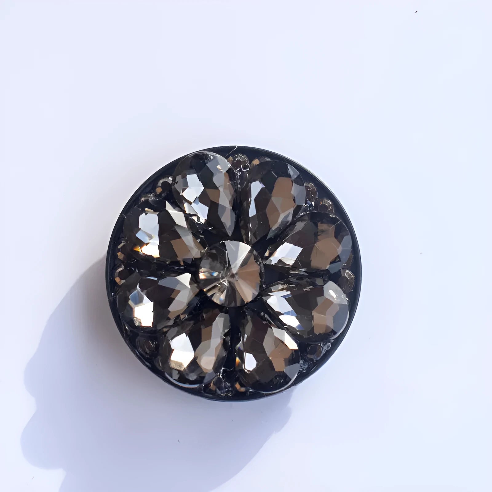 Rhinestone ring bracket phone holder attached to a mobile phone on a desk, shown in multiple colour options.