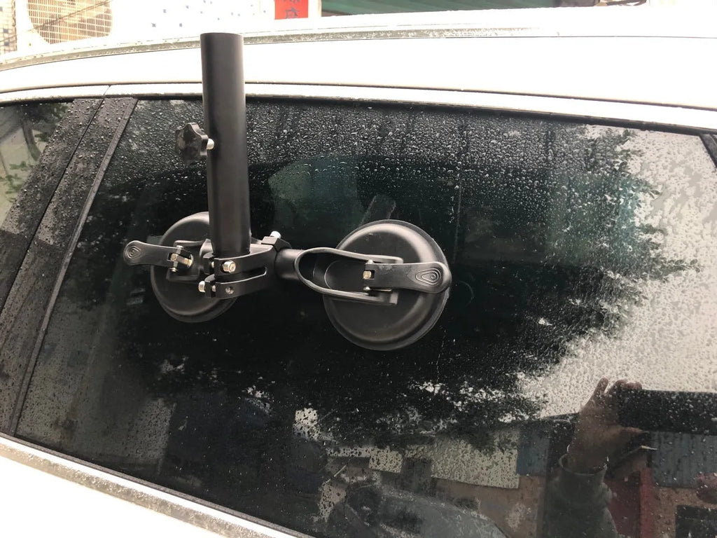 Black off-road car windscreen sucker mount with a large round rubber suction cup for flagpoles.