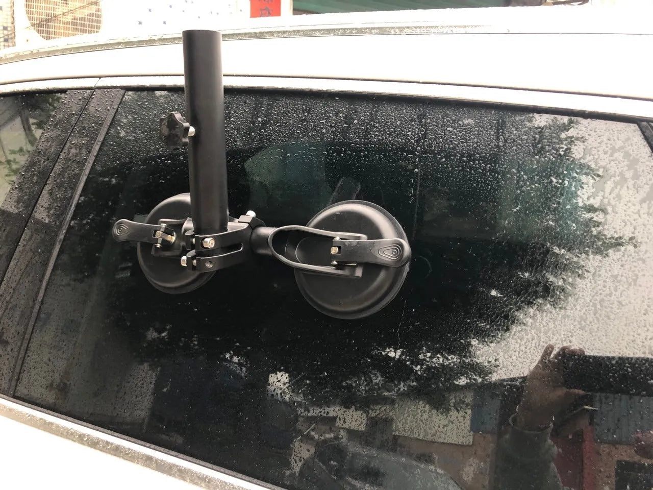 Black off-road car windscreen sucker mount with a large round rubber suction cup for flagpoles.