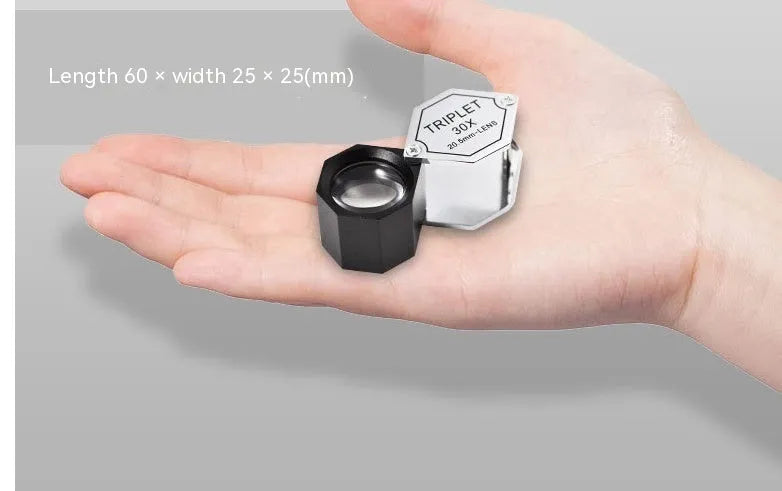 Handheld metal portable magnifying glass for jewellery and coin identification with optical glass lenses.