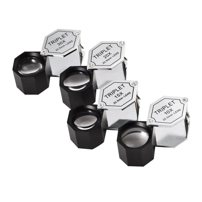 Handheld metal portable magnifying glass for jewellery and coin identification with optical glass lenses.